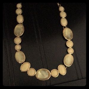 Gold and light tan jeweled necklace.